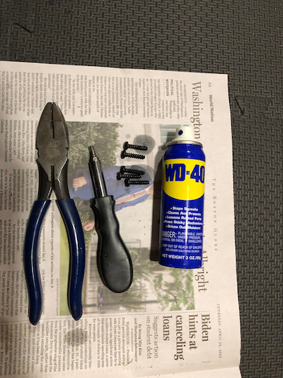 Surgical tools: pliers, torx driver, and WD-40 (with the removed torx screws shown as well