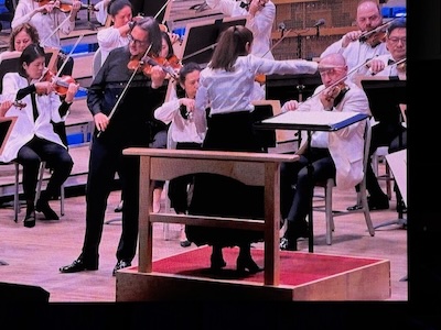 Conductor Elim Chan: tiny woman, on platform, in heels