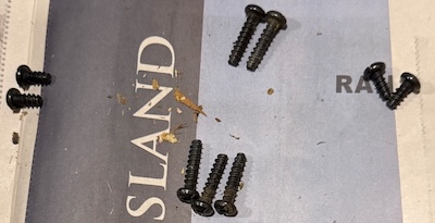 Battery surgery: screws extracted, laid out geometrically by whence they came